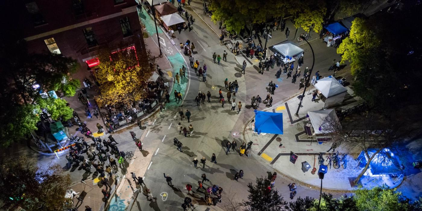Crowds of people seen from above on the streets of Winnipeg's Exchange District for Nuit Blanche.
