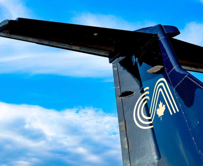 Close up on the Calm Air logo on the tail of an airplane.