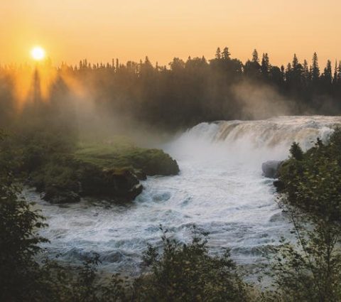 Sunset through the rising mist at Pisew Falls.